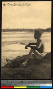 Young boy fishing from a riverbank, Congo, ca.1920-1940