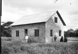 Five men in front of a stone house, Tanzania, ca.1893-1920