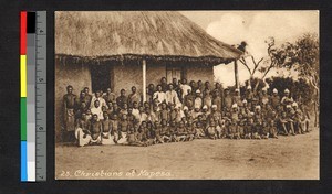 Christians assembled outside a thatch-roofed building, Angola, ca.1920-1940