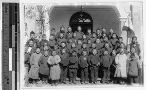 Father Vincent Lebbe with a large group of smiling Chinese boys, China, ca. 1910-1930