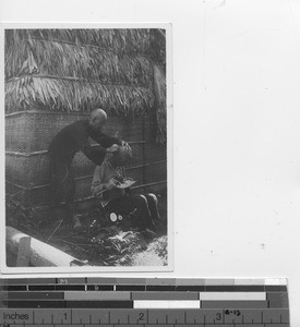 Getting a haircut at leprosarium at Jiangmen, China