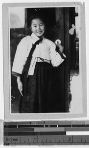 Smiling girl holding white doorknob, Yeng You, Korea, ca. 1920-1940