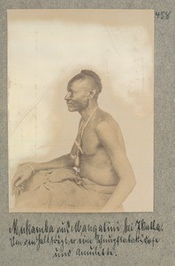 Mukamba from Mangatini near Ikutha. Around his neck he is wearing a snuffbox and amulets, Kenya