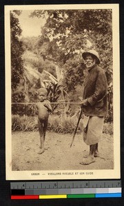 Old man with cane being guided by small boy, Gabon, ca.1920-1940