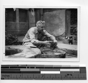 Fr. Dempsey washing clothes at Kunming, China, 1945