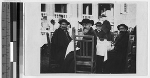 Four European clergymen sharing a meal, ca. 1910-1930