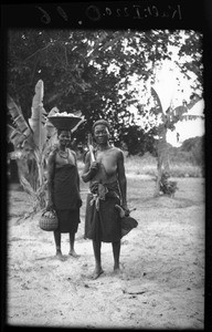 African woman carrying cashew nuts for distillation, Mozambique, ca. 1933-1939