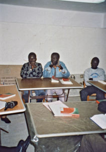 Three Sudanese refugees participating in an educational project called theology for lay people