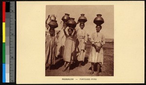 Young women carrying clay water jars on their heads, Madagascar, ca.1920-1940