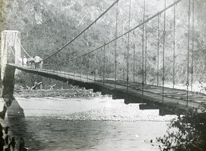 Mission party crossing bridge, Peru, ca. 1947