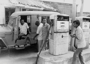 Mechanical refueling at Dumka, North India, April 1988. Bishop Sagenen Kisku is sitting in the