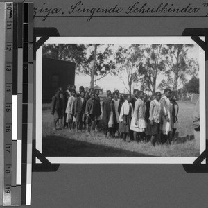 Singing schoolchildren with the teacher assistant Mbiyo, Baziya, South Africa East