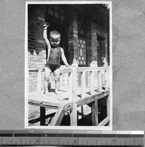 Child on walkway at Harwood Bible Training School, Fenyang, Shanxi, China, ca.1936-37