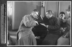 Discussing a Christian tract, Jinan, Shandong, China, 1941