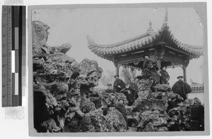 Bishop Reynaud and other missioners walk along the shore of Lake Si-ou, China, ca. 1910-1930