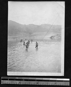 Boat workers walking through water, Sichuan, China, ca.1912