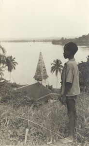 Boy looking at the landscape, in Lambarene, Gabon