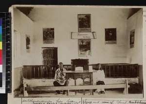 Missionary's wife and Malagasy man and woman inside chapel, Madagascar, ca.1900