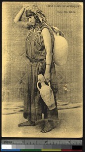 Young Kabyle woman carrying clay jars, Algeria, ca.1900-1930