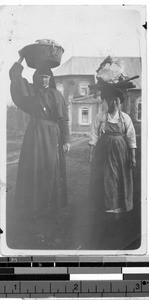 Maryknoll Sister Sylvester and Korean woman carrying laundry, Gishu, Korea, 1925