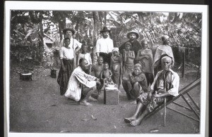 An African family eating together on the way home from celebrating a baptism (Cameroon)