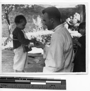 Fr. Thomas A. O'Neill and orphan at Yangjian, China, 1935