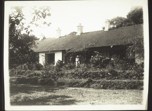 At tea in the garden in Kotageri. An old tree-stump serves as a table. April 1932