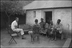 Rev. Jacques Maury talking with people among whom two fetichist men