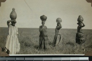 Women carrying beer pots, South Africa