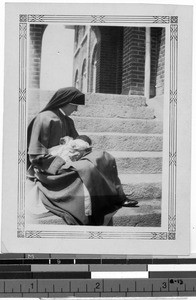 Sister Sylvester Collins, MM, holding an infant, Korea, ca. 1928