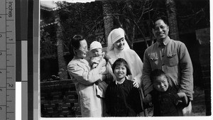 Maryknoll Sister with local family, Guilin, China, 1949