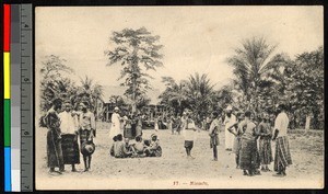 Missionary fathers standing with others on a grassy field, Congo, ca.1920-1940