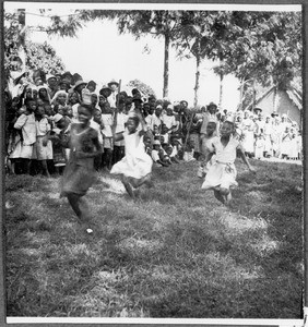 Children's games: Girls jumping with containers on their heads, Gonja(?), Tanzania, ca. 1927-1938