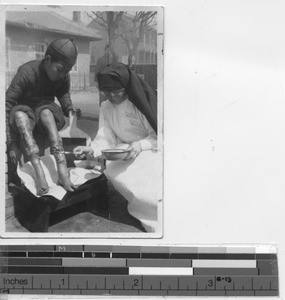 Sister Paula treating leprosy at Andong, China, 1938