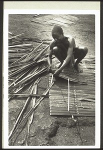 Preparing mats made of palm-leaves which will be used to cover the roof of the church in Eso