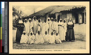 Missionary sisters pose with leprous men and women, Harer, Ethiopia, ca.1900-1930