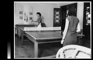 Women students playing ping pong in the dormitory common room, Yenching University, Beijing, China, 1941