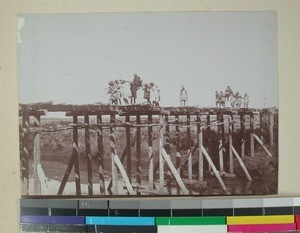 Missionaries Anders Rustad and Anders Olsen crossing a wooden bridge, Madagascar, 1901