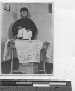 A girl shows cross-stiching at Andong, China, 1926