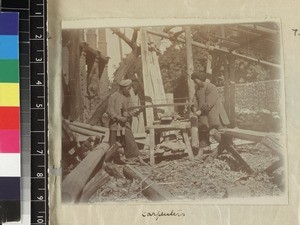 Two Chinese carpenters sawing wood, Fujian province, China, ca. 1888-1906