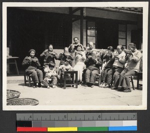 Women and children eating outside the Industrial Mission, Guangdong, China, ca.1920-1937