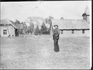 Missionary Blumer in front of the church and school buildings, Arusha, Tanzania, ca. 1920-1930