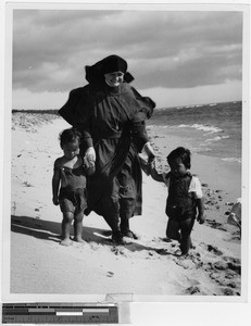 Sister Adrienne Mundy, MM, with Bolo and Conchita on Kihei Beach, Hawaii, 1944