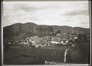 Suburb of Junon with graveyard in the background. The mountains are bare of trees