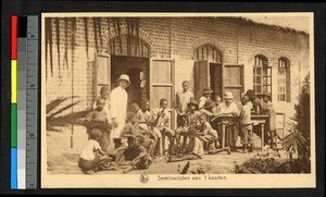 Missionary fathers standing outside a brick building with others, Congo, ca.1920-1940