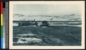 Wooden chapel on a plain of bare earth and snow, Alaska, ca.1920-1940