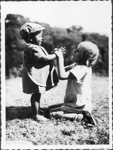 Marianne Guth playing with a toddler, Tanzania, ca.1927-1934