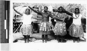 Four people in grass skirts, Oceania, ca. 1920-1940