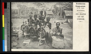 Women sitting outdoors with spinning wheels, Congo, ca.1920-1940