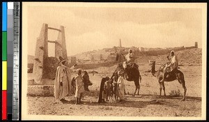 People gathered with camels in front of a mosque, Ghardaïa, Algeria, ca.1920-1940